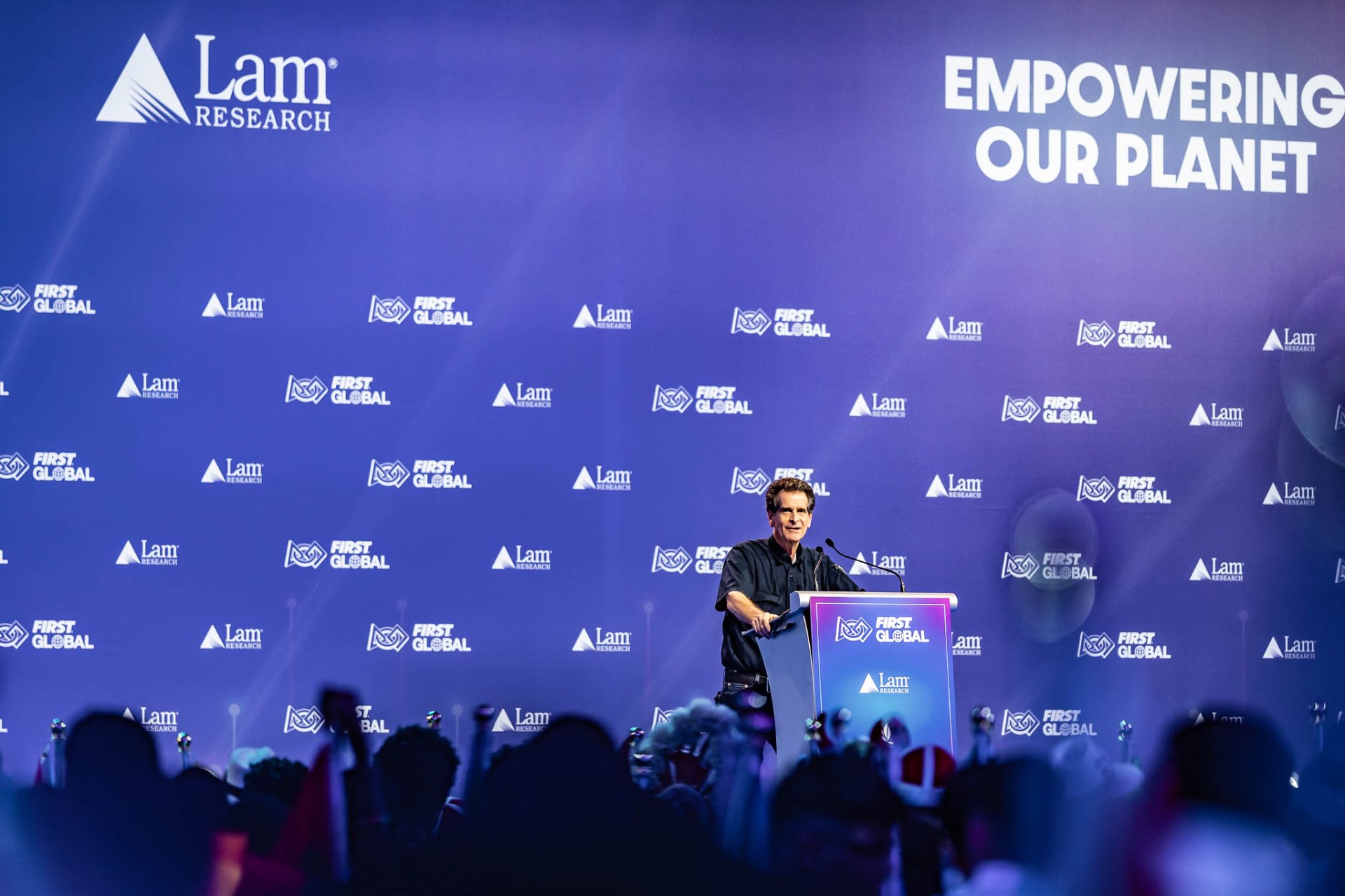 FIRST Global keynote speaker on Lam Research stage in Singapore — conference photography
