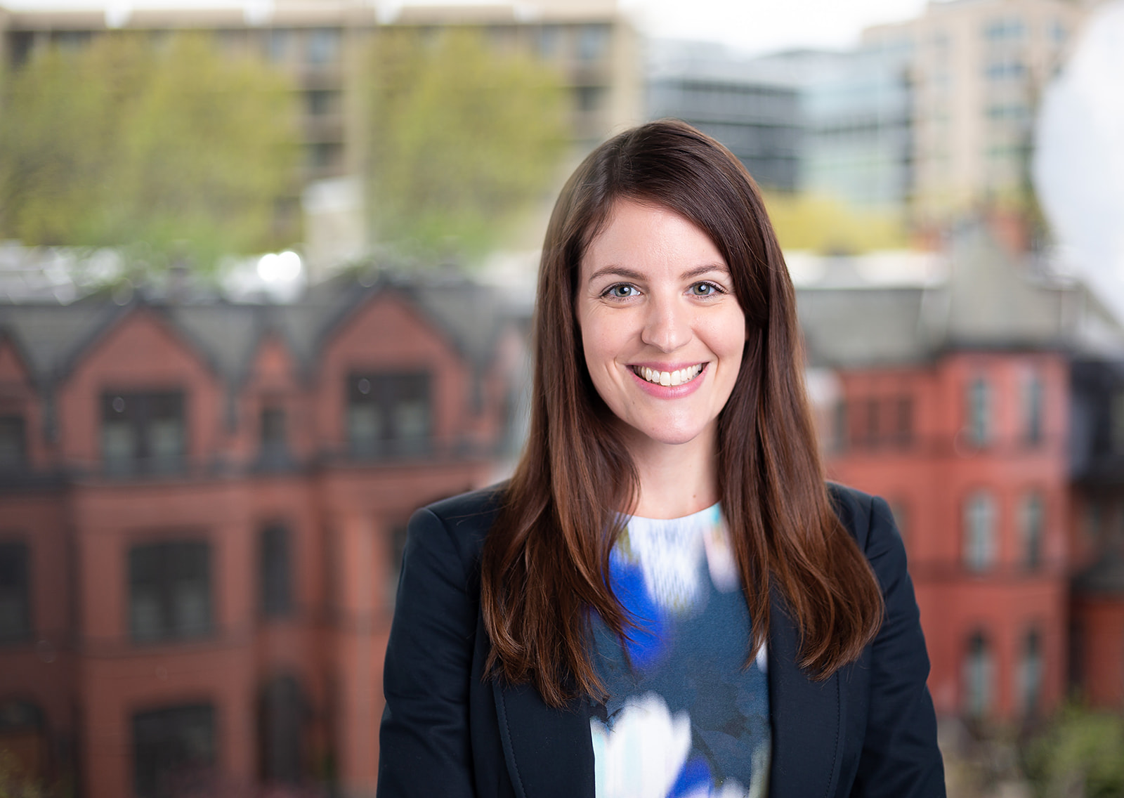 Corporate headshot with cityscape backdrop — environmental portrait
